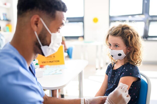 Pediatrician reviewing the vaccination record of a school-age child