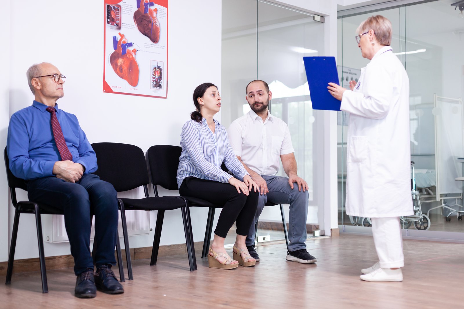 Middle-aged couple consulting a cardiologist for a preventive heart health check-up.