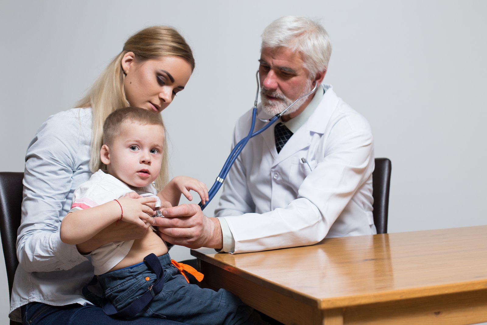 Pediatrician examining a child with fever to diagnose the cause of infection in Kukatpally