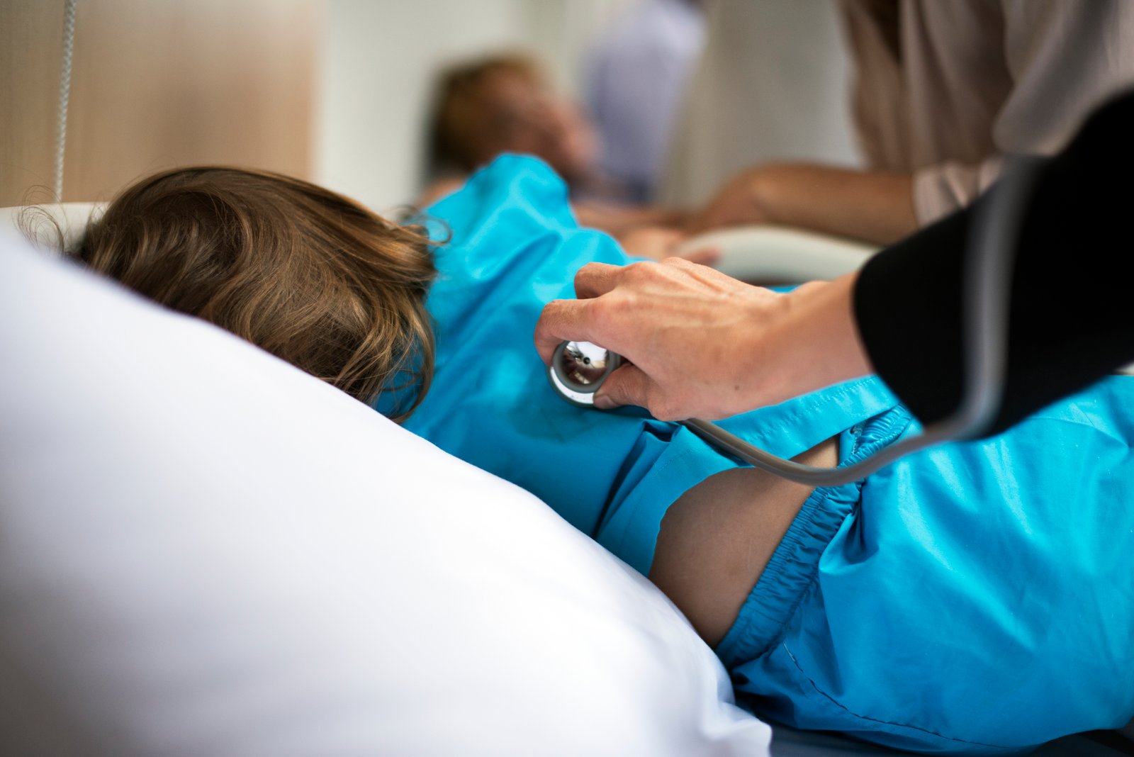 Pediatrician examining a child with persistent fever at a children's clinic in Kukatpally