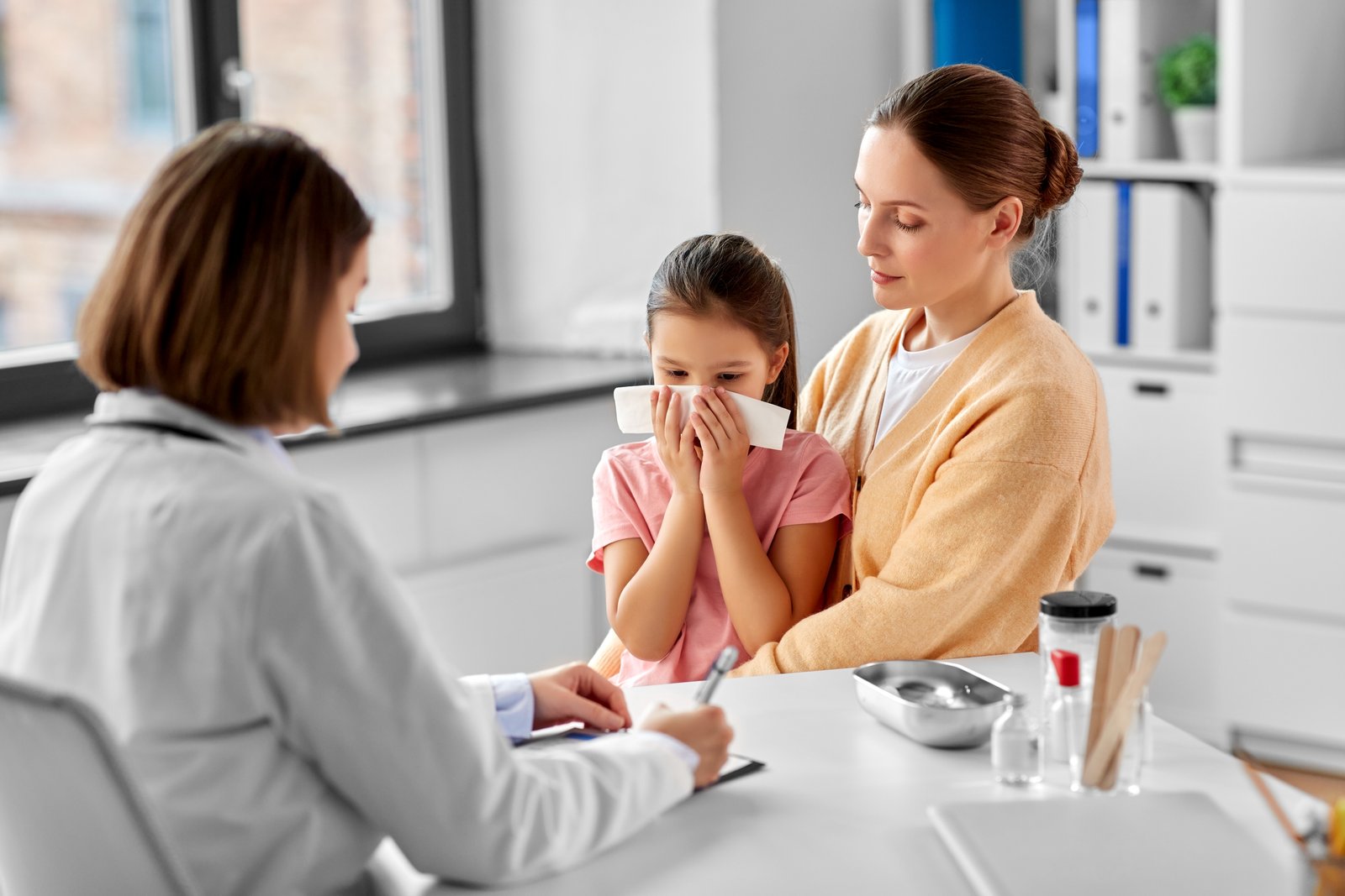 Pediatrician examining a child with fever at Srinidhi Children's Clinic in Kukatpally